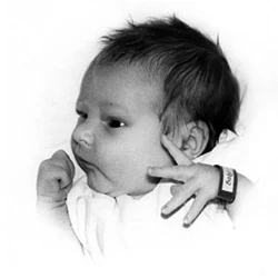 Close-up black-and-white photo of newborn Paul Hamon, with a hospital identity bracelet visible on his wrist.