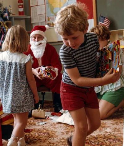 Paul Hamon receiving a present from Father Christmas at playgroup, Pooraka, December 1976