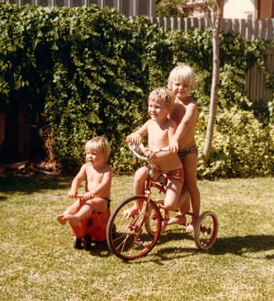Paul Hamon (5), Mark Hamon (2) and aunty Kerry Drogemuller with the red tricycle, Pooraka, Summer 1977