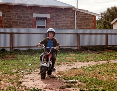 Paul Hamon aged 7 riding a minibike, Pooraka, Adelaide, c. January 1980